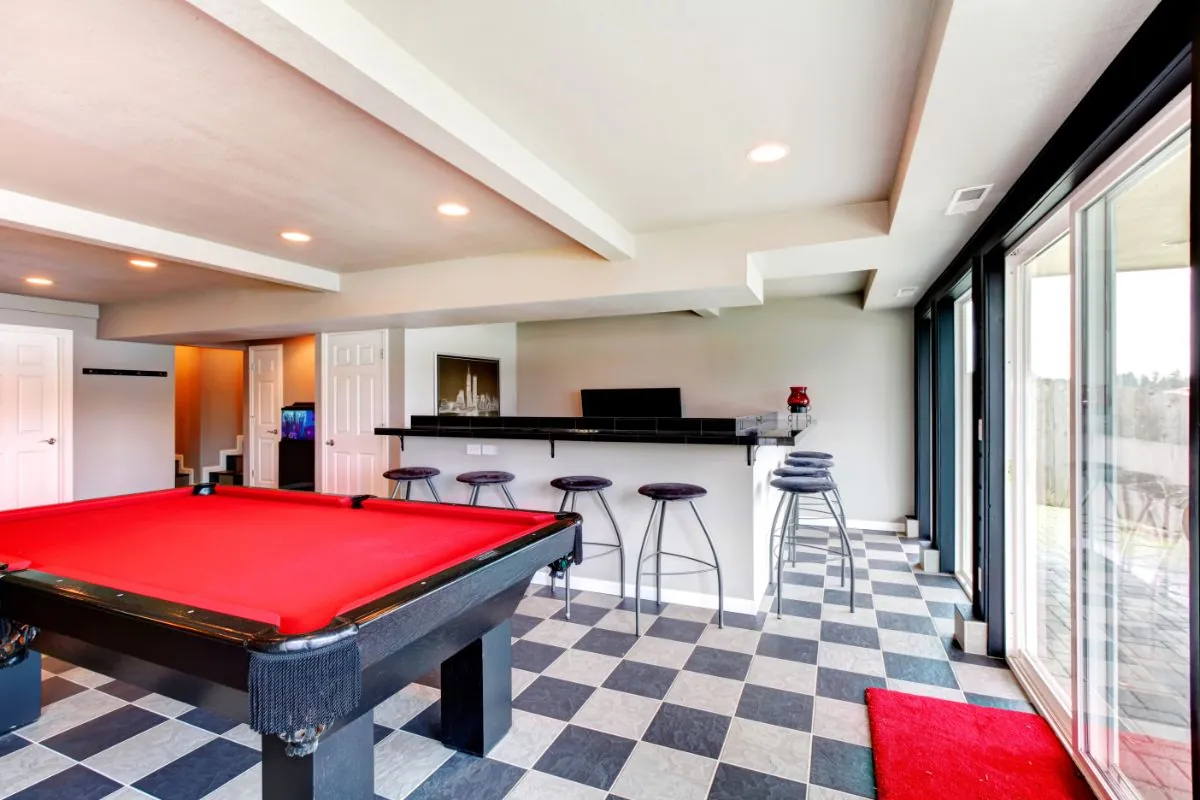 elegant entertainment room with pool, bar and fireplace